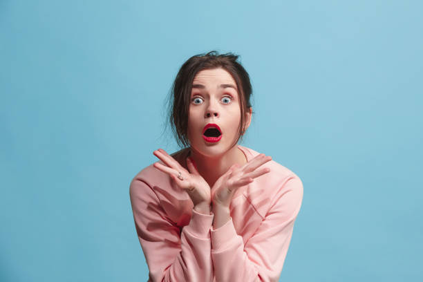 istock Beautiful woman looking suprised isolated on blue 919781934