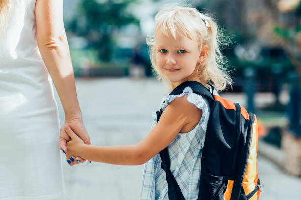istock Content Schoolgirl Holding Mother Hand 919782300