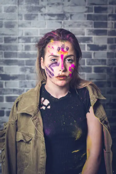 Portrait of a young woman with colors on her face