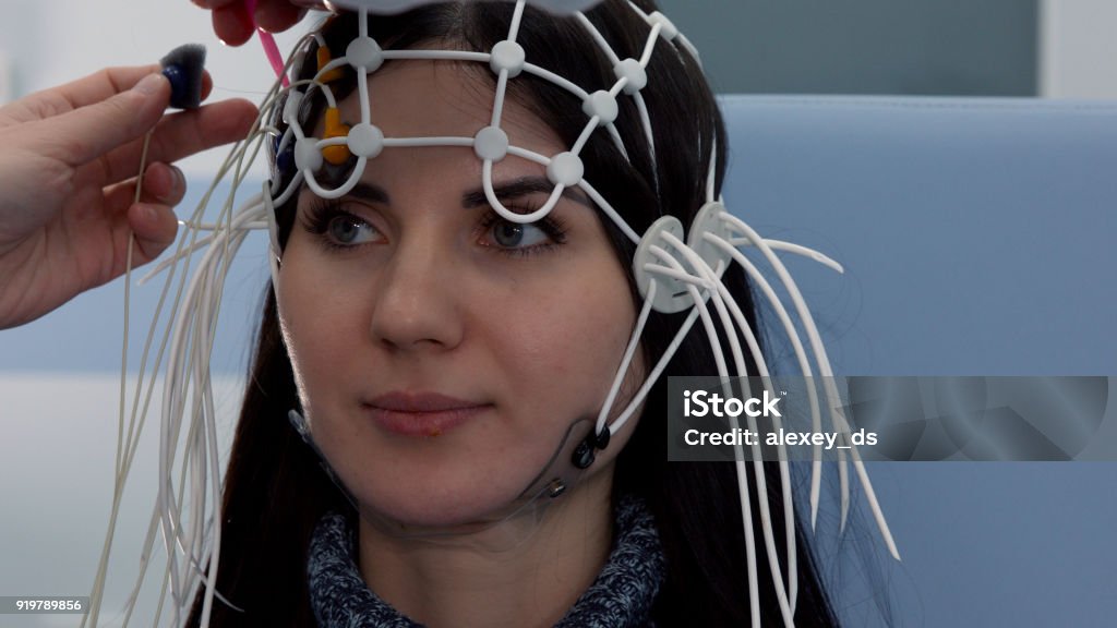 Female patient getting EEG exam Brain Wave Stock Photo