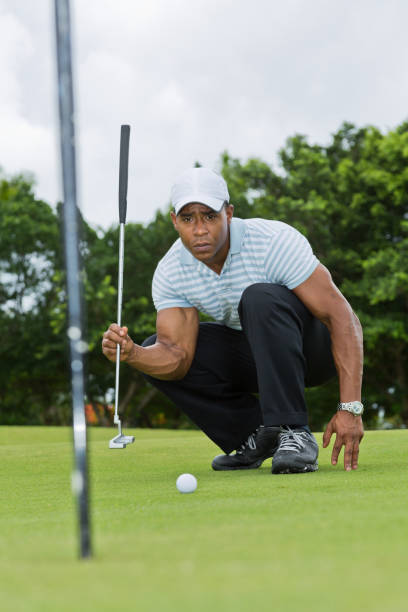 istock African-American male golfer reading the line 919789980