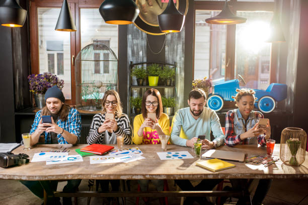 istock Friends sitting with phone in the cafe 919790592
