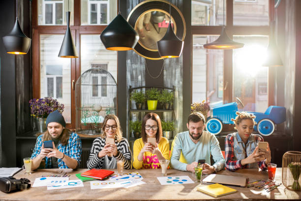istock Friends sitting with phone in the cafe 919791898