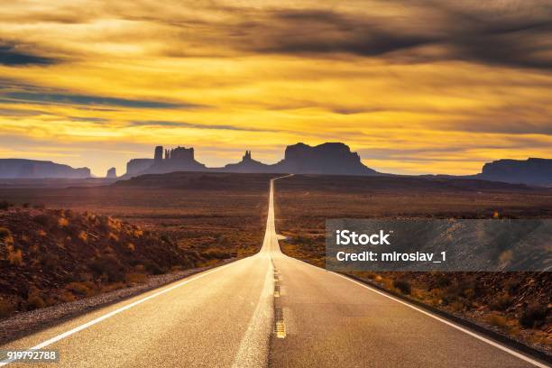 Desert Road Leading To Monument Valley At Sunset Stock Photo - Download Image Now - USA, Road, Road Trip