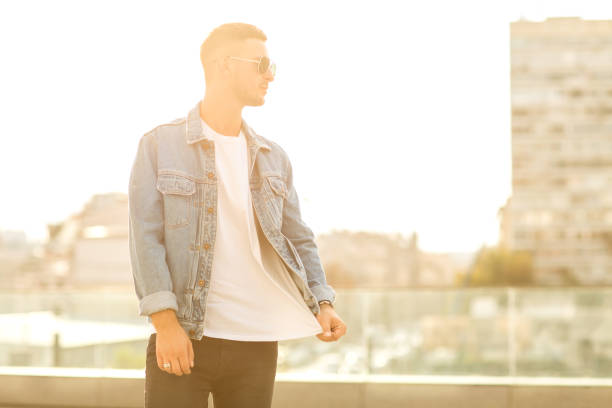 istock fashion guy posing in sunglasses on sunset 919793302