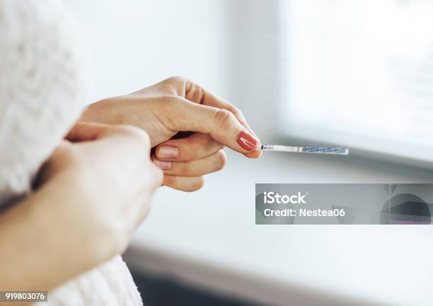 Test Of Pregnancy In Hands Stock Photo - Download Image Now - Ovulation, Contraceptive, Holding