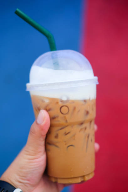 istock Iced coffee in plastic glass in man hand 919818710