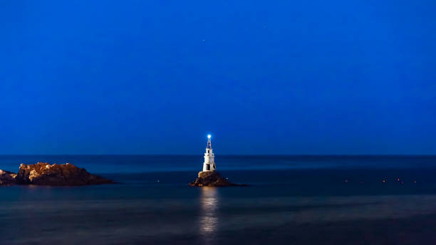 istock Ahtopol Bulgaria lighthouse and a pier at night 919824026