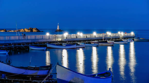 istock Ahtopol Bulgaria lighthouse and a pier at night 919824040