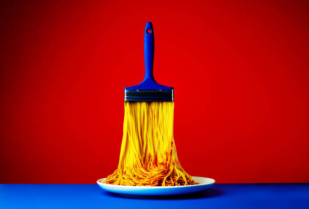 Art brush noodles creative combination on plate against red background