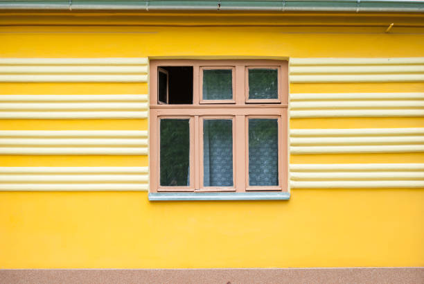 istock Yellow house with a window in the middle 919825308