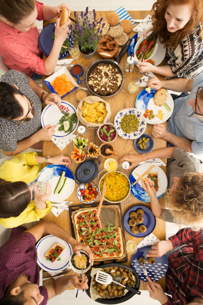 istock People eating hummus and pizza 919826500