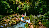 Solo Traveler crossing wooden bridge at Puente de Dios in San Luis Potosí Mexico