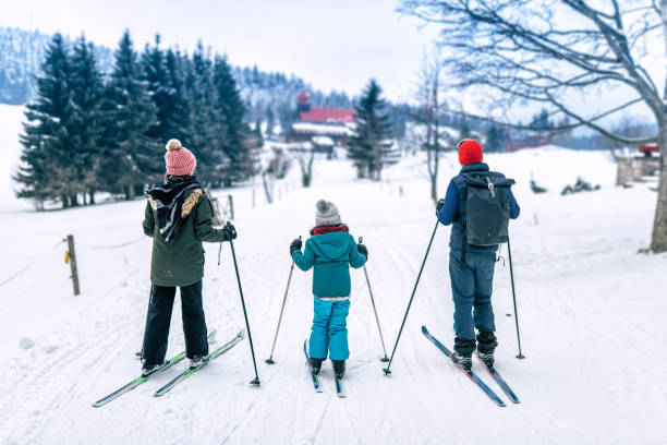 family in snowy winter landscape on cross-country-ski father with two daughters in snowy winter landscape of giant mountains on cross-country-ski karkonosze mountain range photos stock pictures, royalty-free photos & images