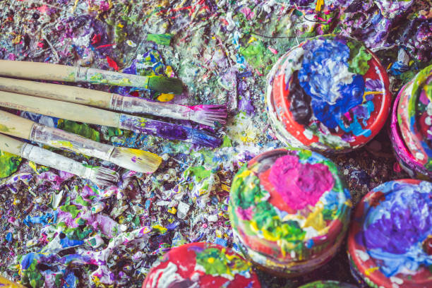 istock Paintbrush and paint bottle with colorful paint spot on the surface 919868400