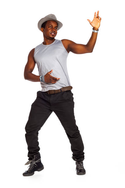 Brazilian man is posing and dancing in cool cloths with hat in front of wihite background