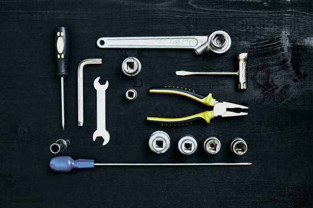 istock Wrench set of pliers socket spanner and screwdriver tools on black wooden background 919905296