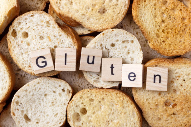 istock gluten text on Background from many small round rusks. Top view 919905556