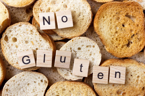 istock No gluten text on Background from many small round rusks. Top view 919905580