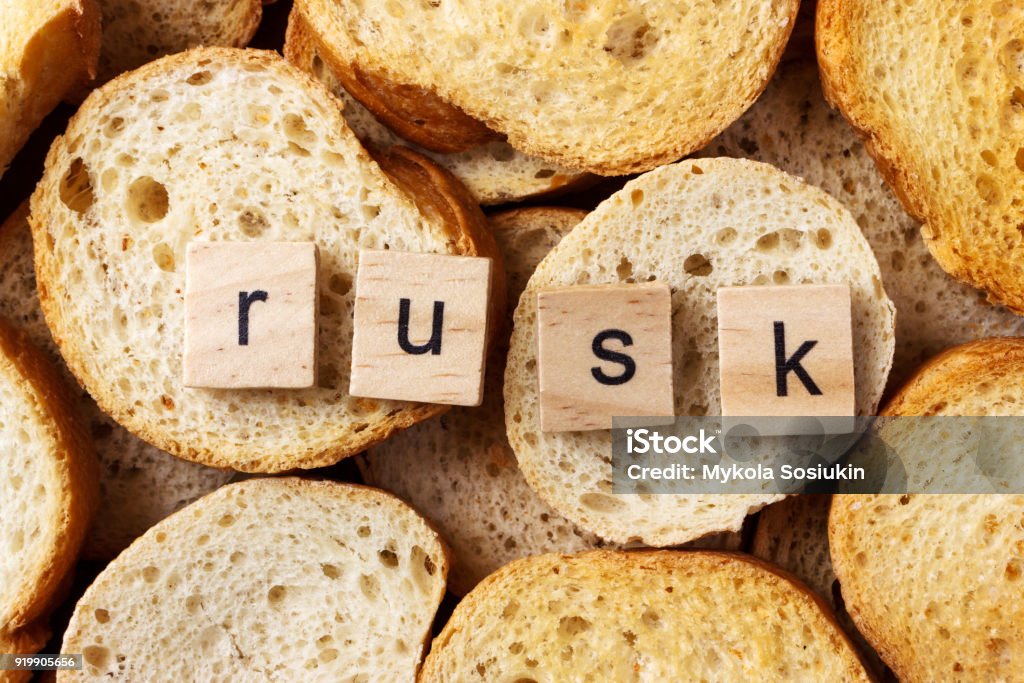 word rusk on many of round rusk background word rusk on many of round rusk background. Appetizer Stock Photo