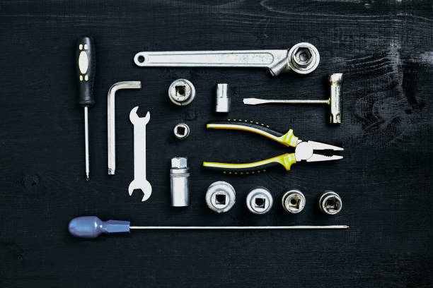 istock Wrench set of pliers socket spanner and screwdriver tools on black wooden background 919906342