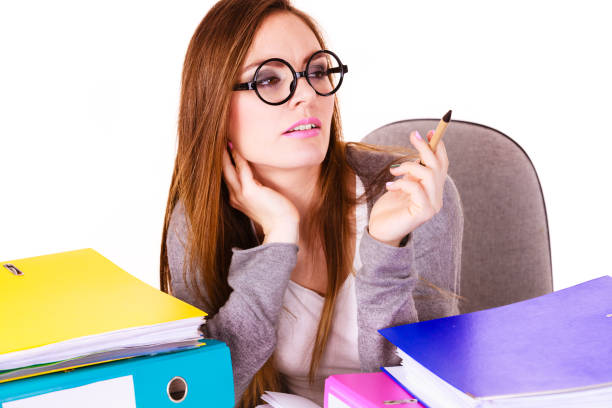 istock Woman sitting at desk in office and thinking 919906452