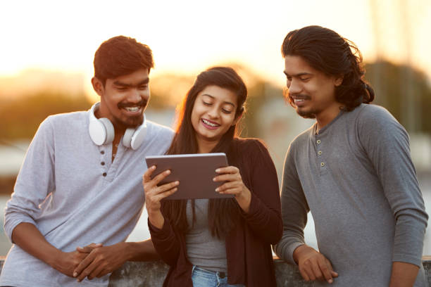 istock Cheerful young friends playing in digital tablet 919910904