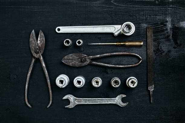 istock Copy space of working tools on a black wooden surface. Nippers, wrench keys, pliers, screwdriver. Top view 919917876