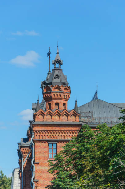 istock tower with an arched bas-relief red brick. elongated cone. on the background of blue sky 919933244