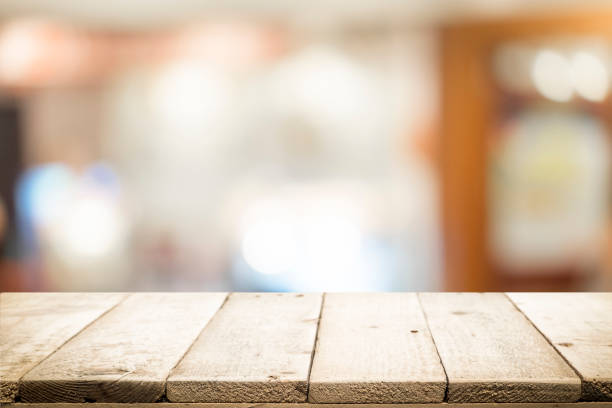 istock Wooden table with blur background of coffee cafe. 919963124
