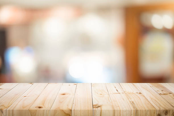 istock Wooden table with blur background of coffee cafe. 919963126