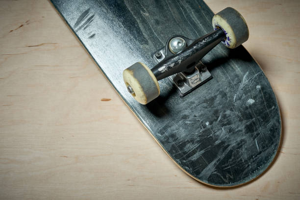 istock used skateboard on a wooden background 919963686
