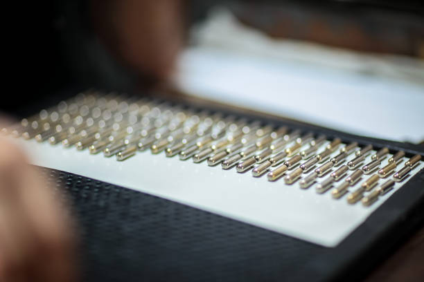 A number of stainless safety pins on white background.