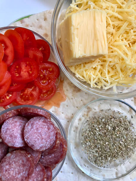 istock Preparation of pizza. Necessary ingredients are on the table. 919984076