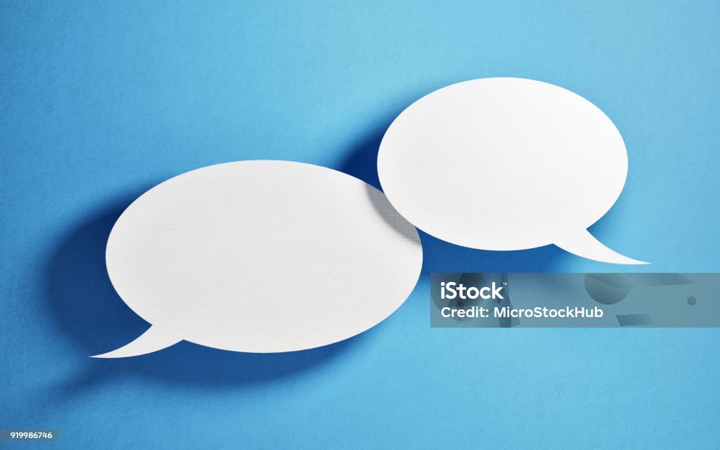 Chat Concept - White Chat Bubbles Over Blue Background White chat bubbles over blue background. Horizontal composition with copy space. Great use for online messaging concepts. Speech Bubble Stock Photo