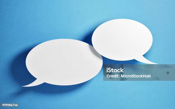 Chat Concept White Chat Bubbles Over Blue Background Stock Photo - Download Image Now