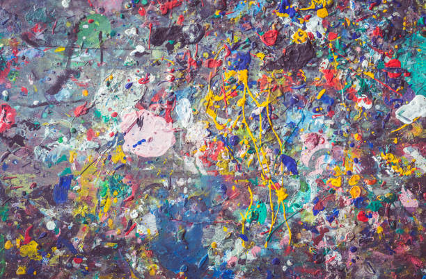 istock Wooden table with colorful paint spot on the surface 919987418