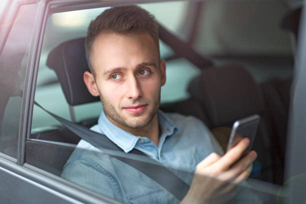 istock Young man sitting in a taxi 919991928