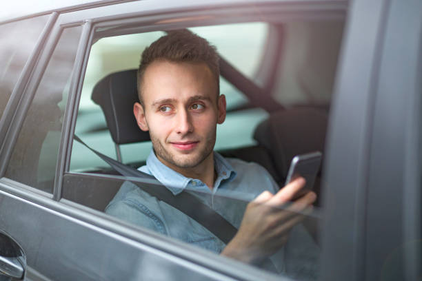 istock Young man sitting in a taxi 919992000