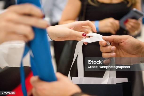 Handing Goodie Bags Stock Photo - Download Image Now - Goodie Bag, Gift Bag, Giving