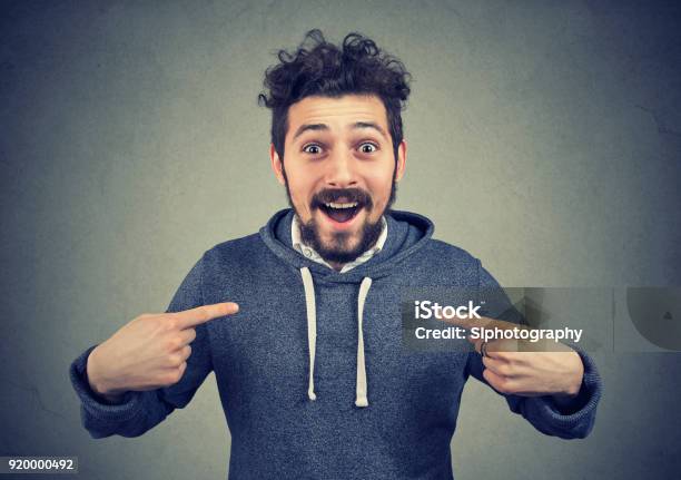 Excited Hipster Pointing At Himself In Astonishment Stock Photo - Download Image Now