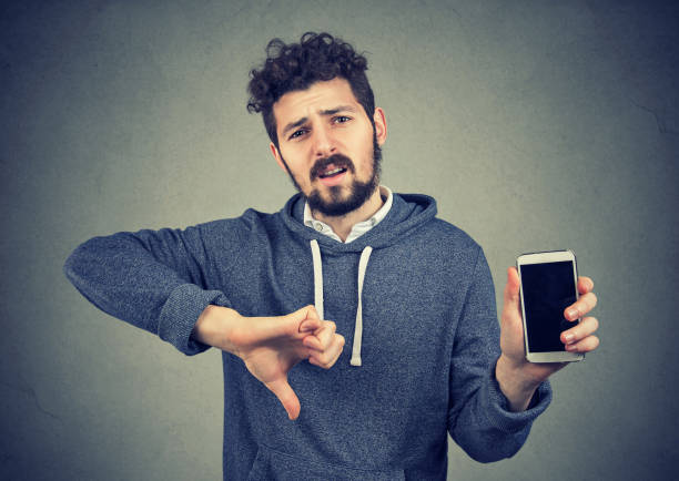 istock Man dissatisfied with quality of gadget 920000572