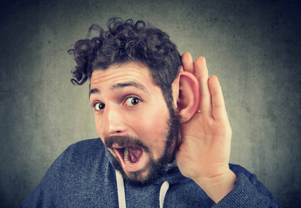 istock young man tries to listen carefully 920000666