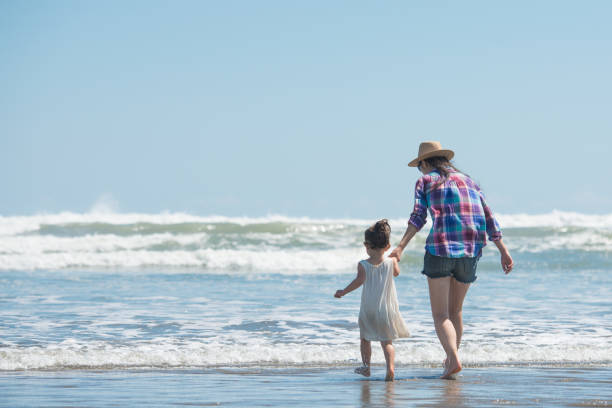 istock Mother and daughter playing on the beach 920001160
