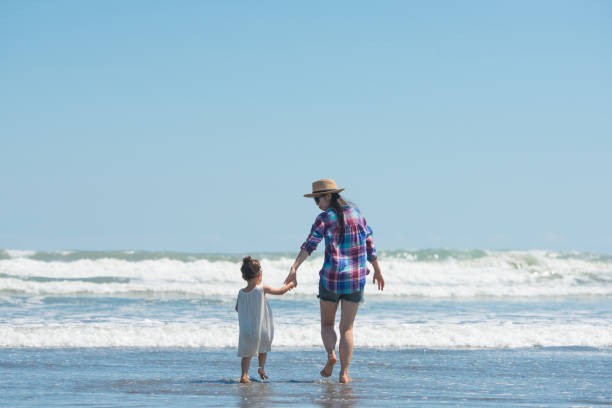 istock Mother and daughter playing on the beach 920001328