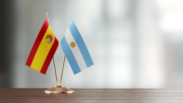 istock Spanish And Argentinian Flag Pair On A Desk Over Defocused Background 920008446