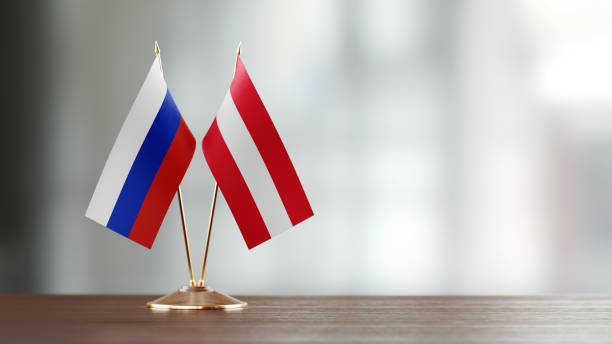 istock Russian And Austrian Flag Pair On A Desk Over Defocused Background 920011558