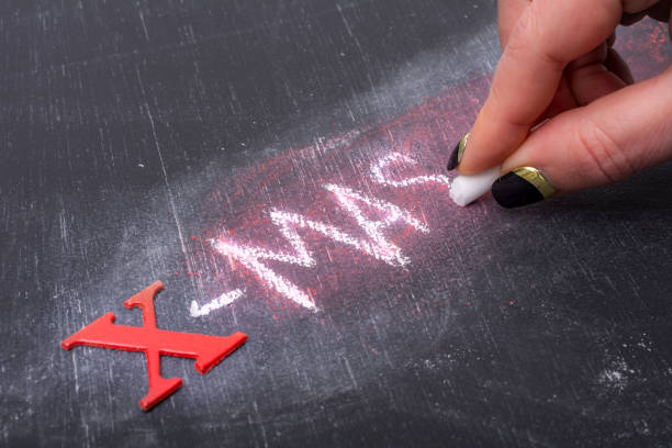istock woman writes x-mas  on blackboard 920014136