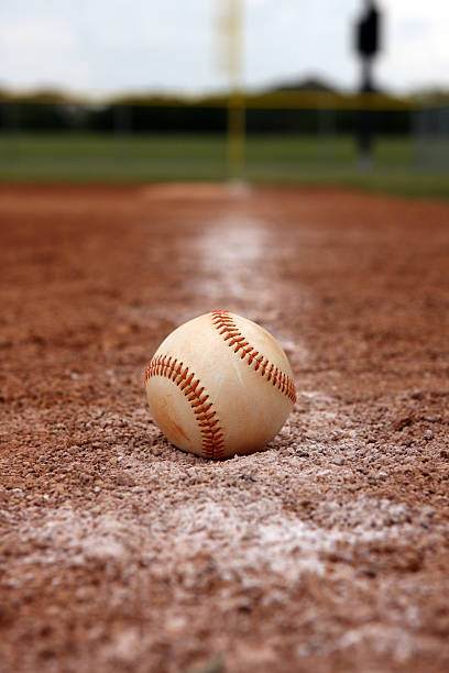 istock Baseball on Chalk Line of the Running Lane 92002224