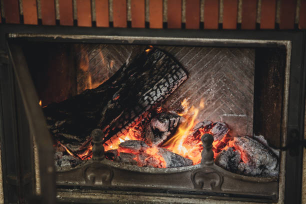istock living fire. Logs are beautifully lit in fireplace 920026922
